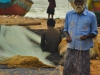Fisherman weaving a net